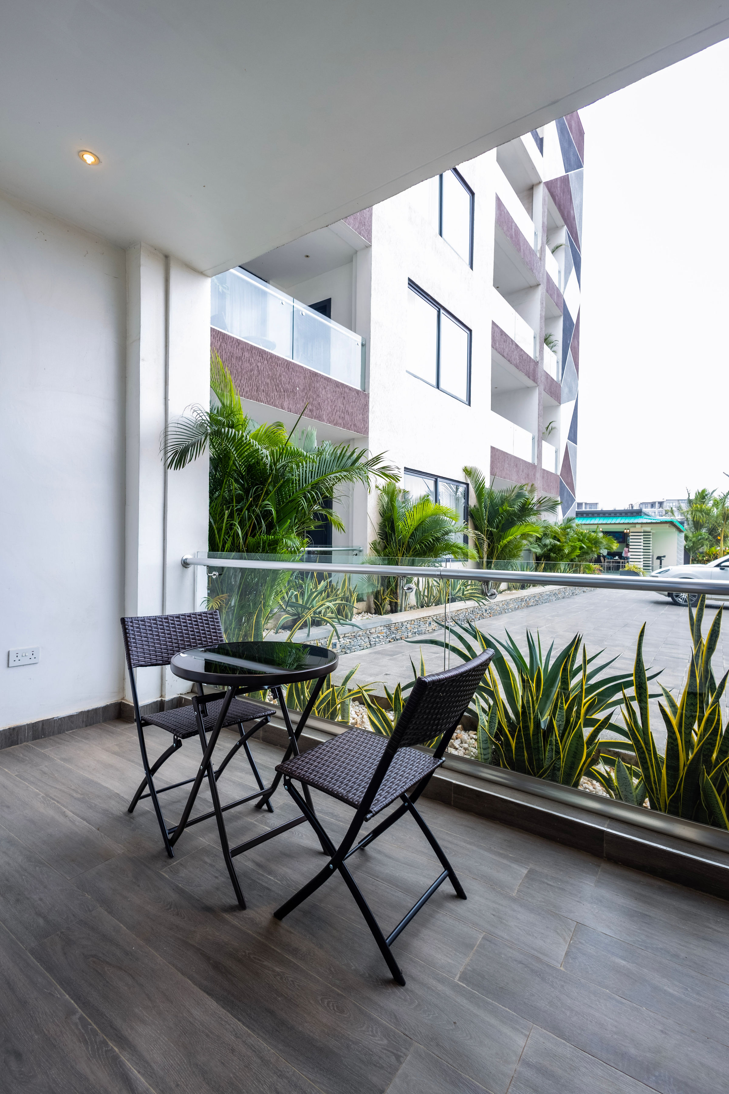 Private balcony with a bistro table and chairs overlooking the grounds